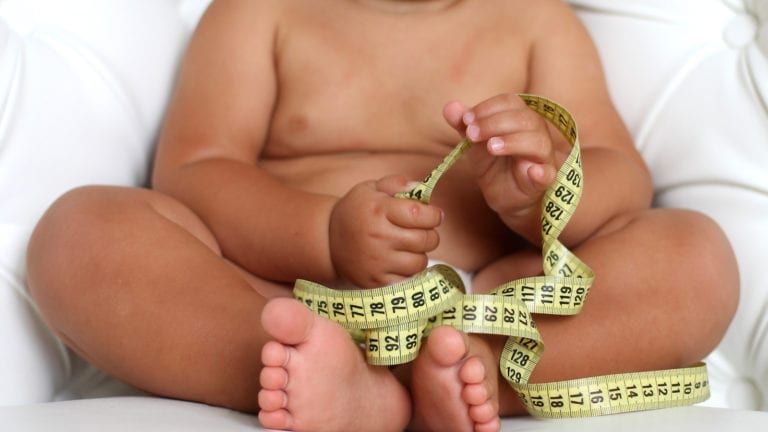 Obese Baby Holding a Tape Measure