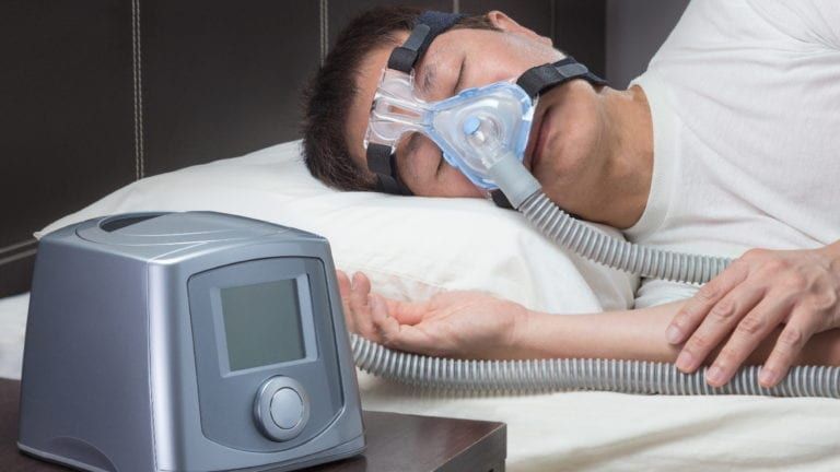 Man sleeping in CPAP machine
